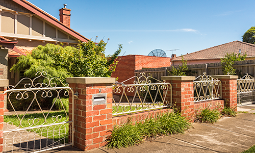 Woven wire pedestrian gate, automatic sliding driveway gate and fence panels on brick fence